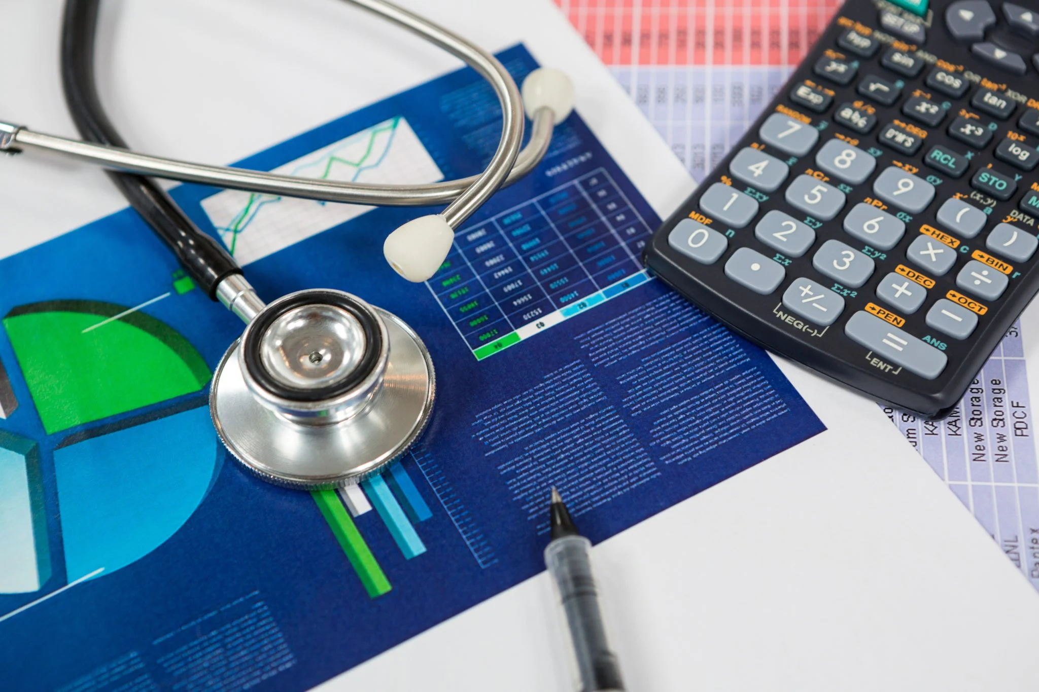 Stethoscope, graph chart, pen and calculator