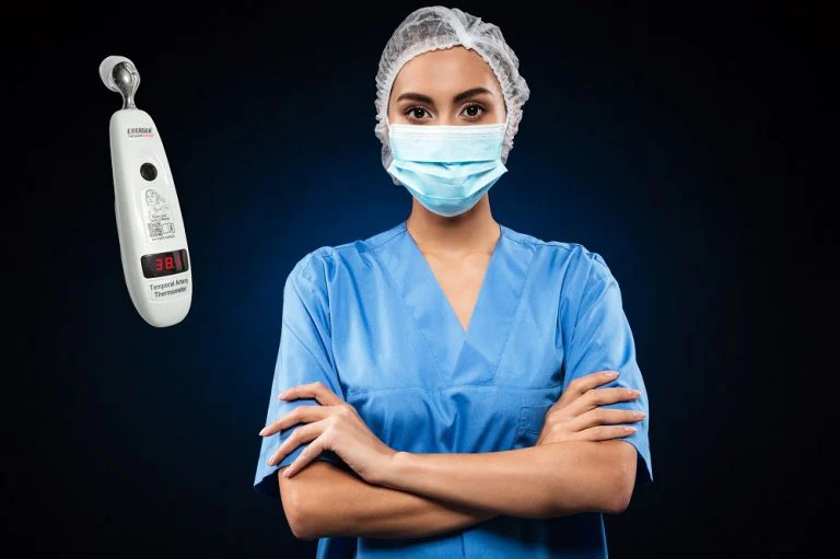 Serious doctor in medical mask and cap looking camera